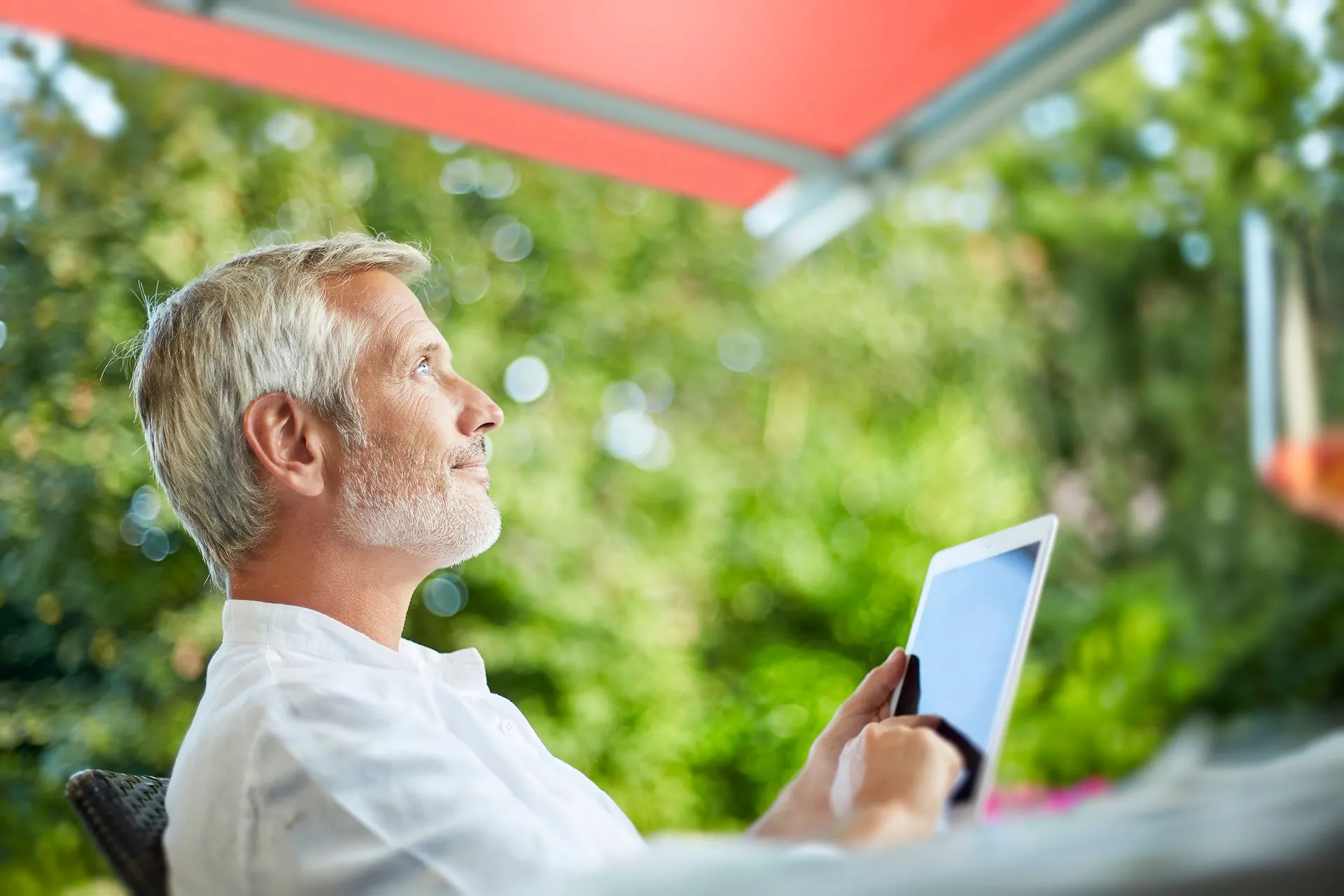 Person controlling their awning with their tablet